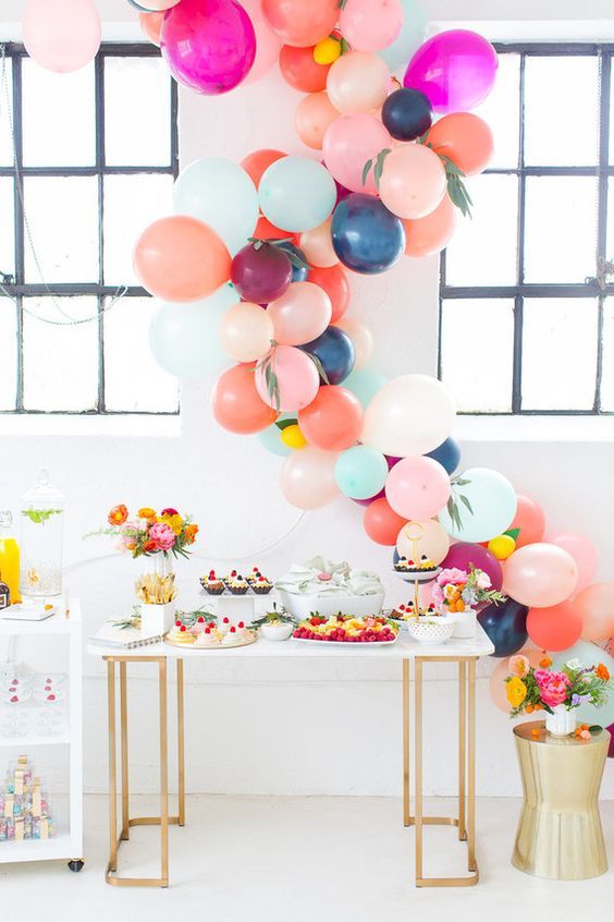 colorful balloon garland as a dessert table backdrop