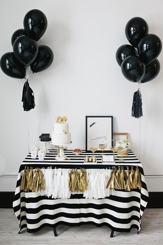 black balloons with tassels for an elegant black, white and gold dessert table