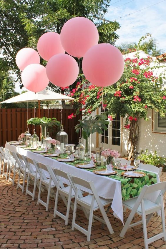 pink balloons attached right to the table for decor