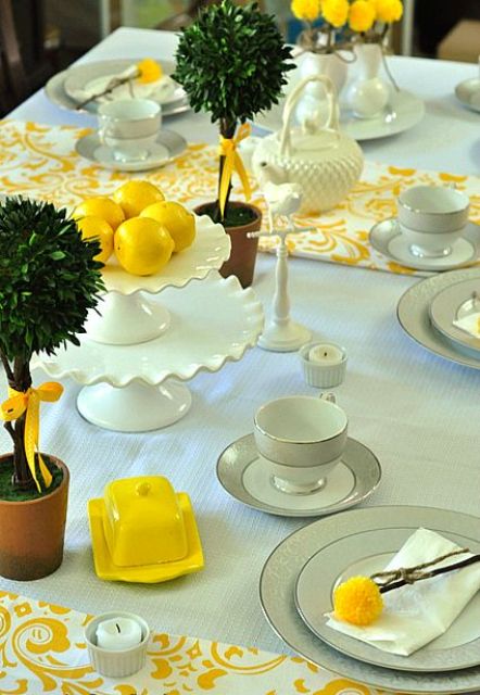 a mint tablecloth with yellow patterned textiles and yellow dishes