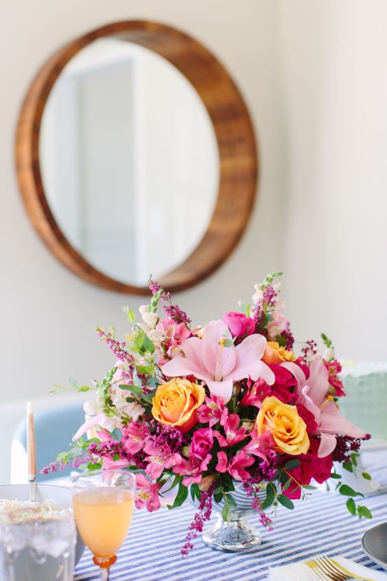 a very colorful floral arrangement in orange, pink and fuchsia