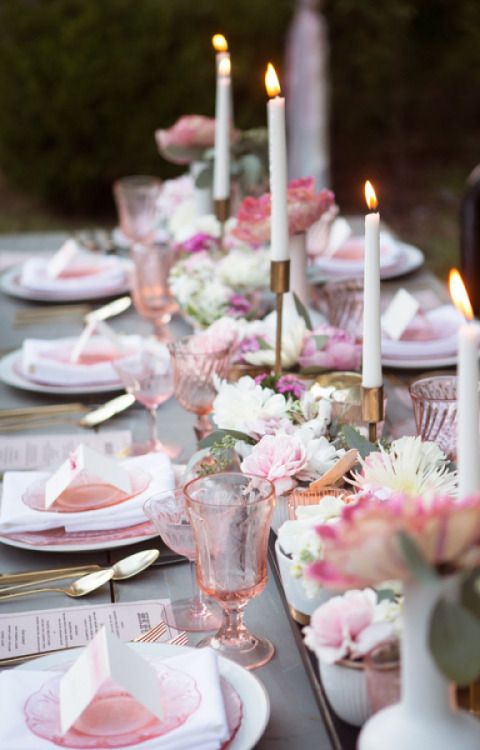 pink glasses and plates echo with pink blooms on the table
