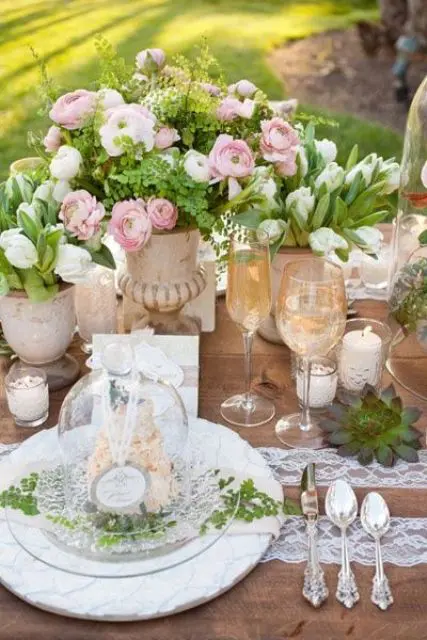 pink ranunculus, white tulips and lots of greenery make this vintage-inspired table fresher