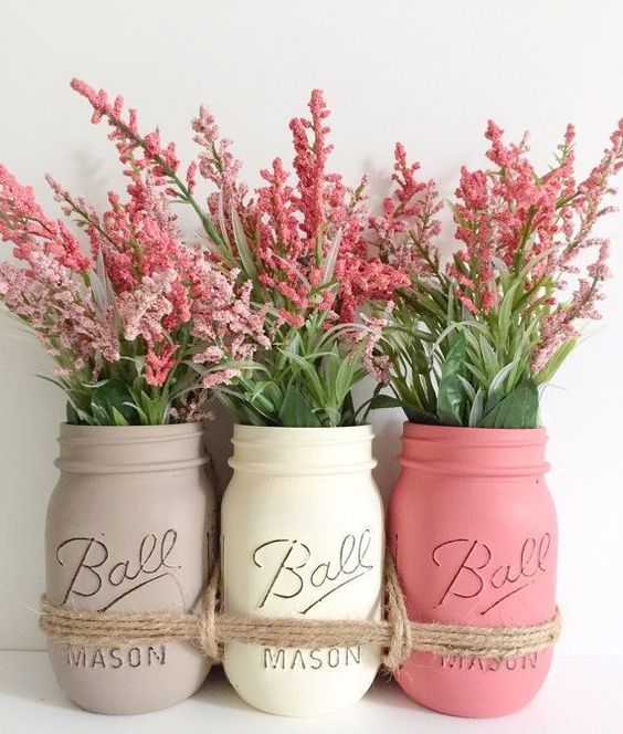 tied up mason jars in soft shades with simple flowers
