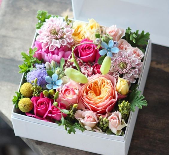 a box filled with various blooms is a cute and easy idea