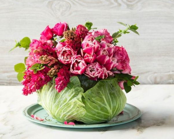 hollow out a hole in a head of cabbage large enough to accommodate a mason jar and fill it with bold flowers