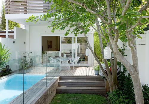 Small Urban Backyard That Features A Nice Pool With A Terrace