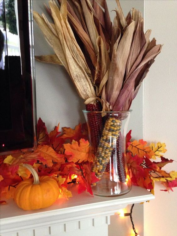 a glass with corn cobs and husks is a cool and simple fall rustic decoration or centerpiece