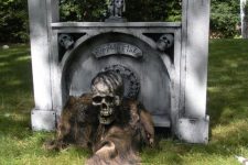 a grave with a skeleton creeping is a very scary and bold idea to decorate your front or backyard for Halloween