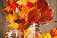 a jar with bright fall leaves is a cool idea for decorating for the fall, it’s fast and easy to realize