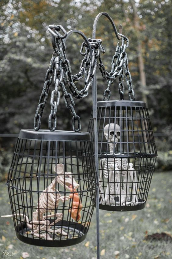 a metal stand with cages with a skeleton and a mouse skeleton is a very creepy and cool decoration for outdoors