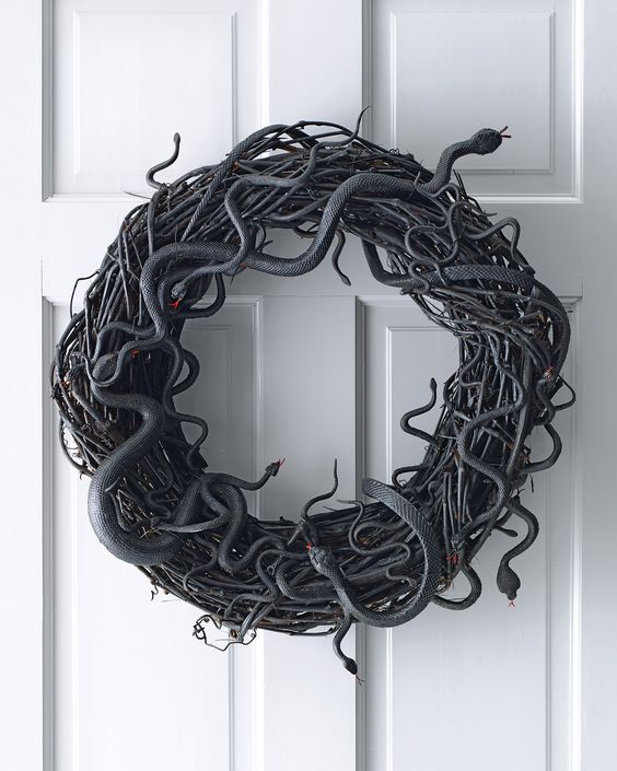 a spooky Halloween vine wreath with lots of snakes is a lovely and bold idea for wall decor