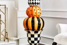 classic Halloween decor with porcelain black, white and orange pumpkins and a mini wreath in the same colors