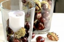 glasses with acorns and pillar candles are a cool decoration or centerpiece for the fall