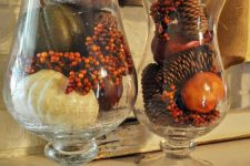 glasses with pinecones, faux berries, faux pumpkins and gourds for decorating a table or a mantel