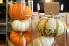 glasses with small pumpkins and gourds are simple and minimal fall decorations to make
