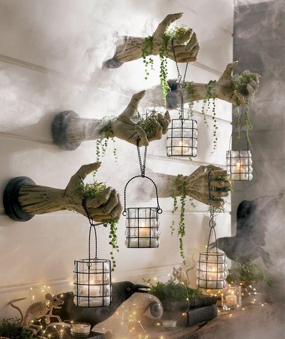 monster hands out of the wall with candle lanterns and greenery are scary and stylish Halloween decor to try