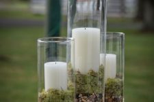 tall glasses with pebbles, moss and pillar candles are a cool centerpiece or fall decoration