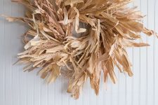 a rustic fall wreath of dried husks and wheat is a cool and budget-friendly fall decoration
