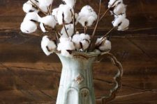 a vintage jug with cotton branches is a cool and veyr easy fall centerpiece with a refined feel