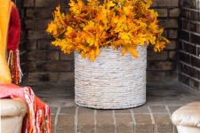 a wrapped vase with colorful fall leaves is a bold and cool fall decoration you cna easily make