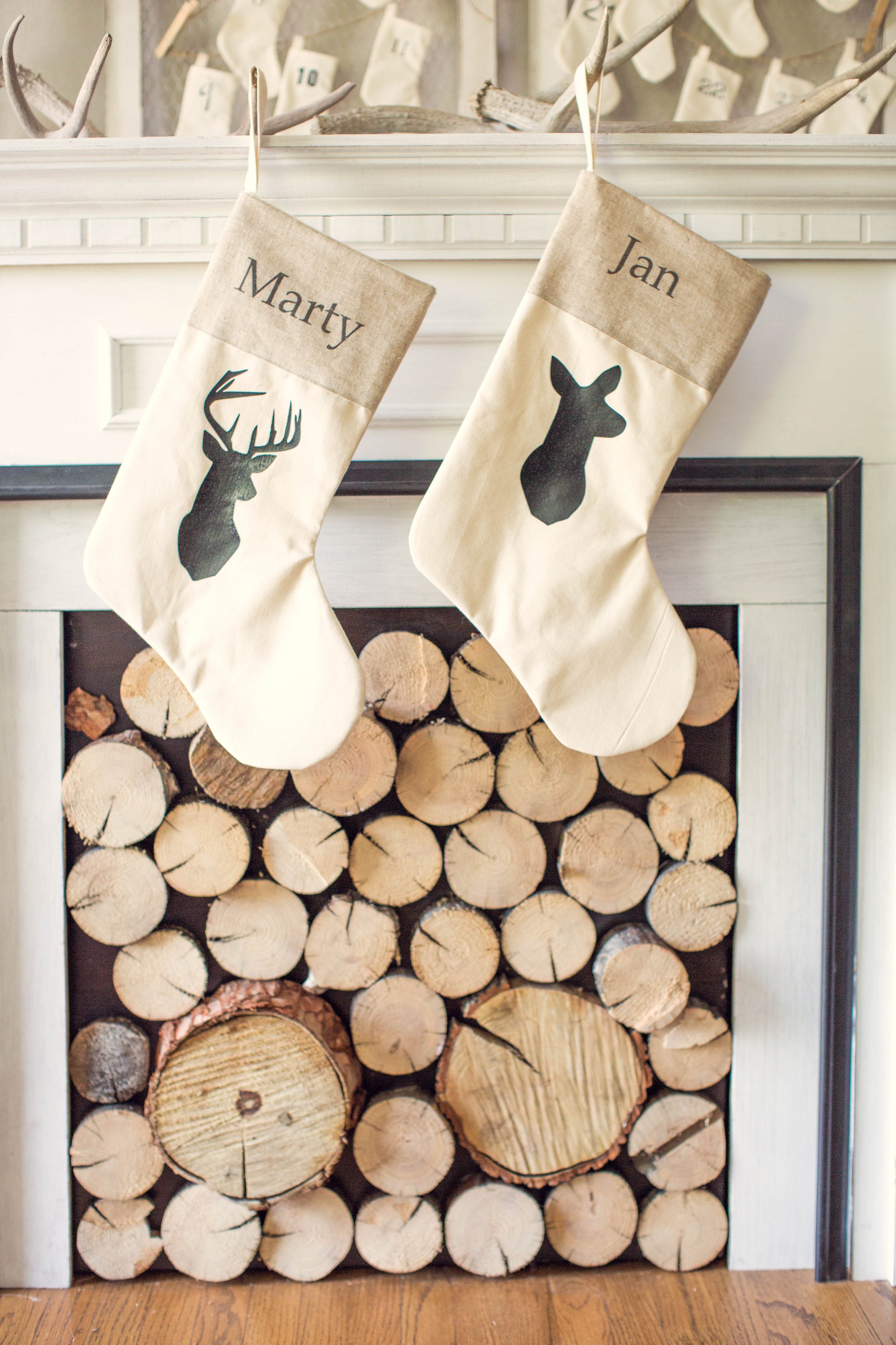 Do you have antlers lying on a mantel or a shelf? If so, they decorate your stockings with deer silhouettes and hang them on these antlers.
