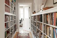 both walls in a long hallway could be used as a home library
