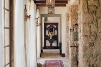 gorgeous farmhouse hallway with lots of natural wood and stone