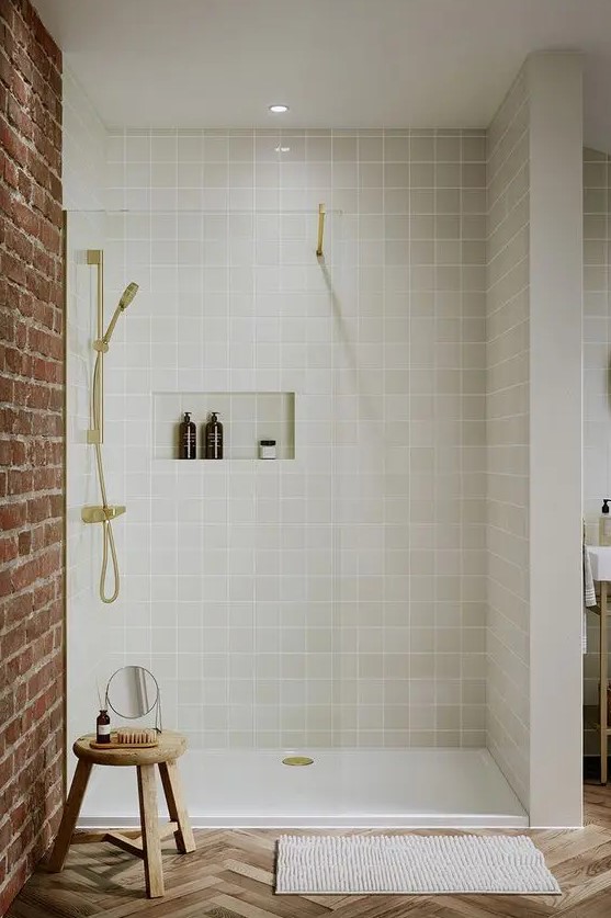 a chic modern shower space clad with grey square tiles, with a niche for storage, gold fixtures is a lovely idea for a modern bathroom