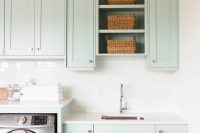 cute laundry room with beauitful cabinets and quartz countetops