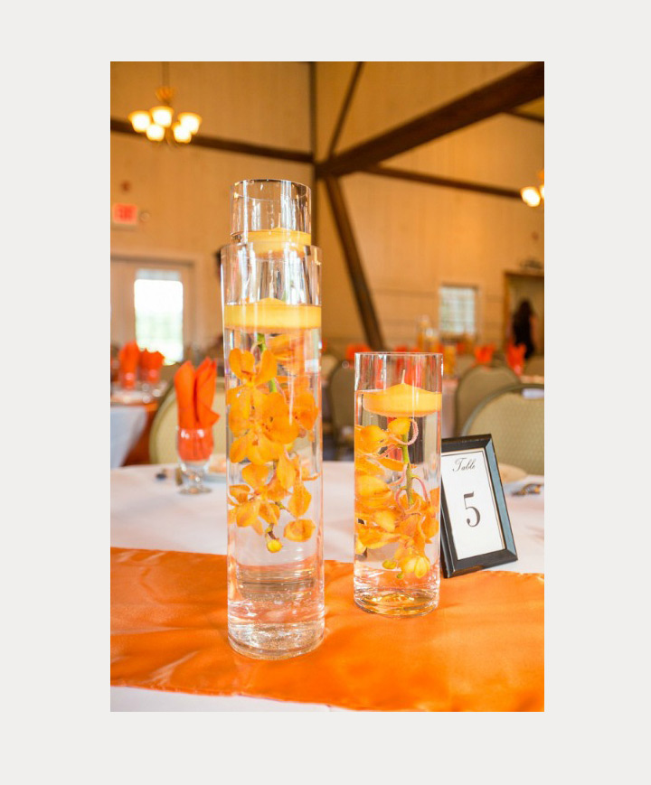 submerged orange orchids with candles are perfect for bright sunny days