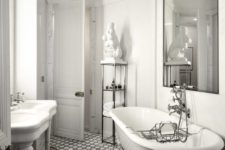 a quirky vintage bathroom with a gorgeous tub, black and white tiles, a gold chandelier and a large mirror over the tub