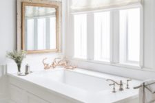 a cool vintage mirror above all white bathtub looks great