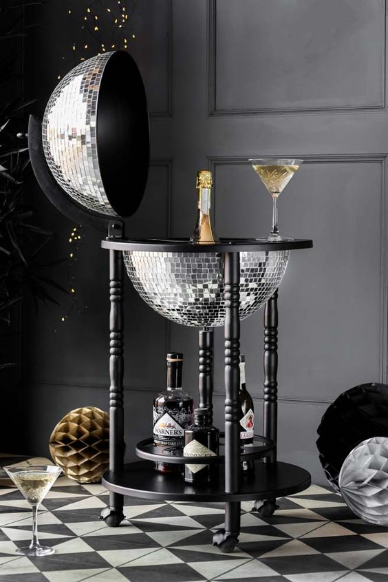 a home bar of a silver disco ball on a black stand on casters is always a good and bold idea