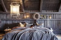gorgeous and moody attic bedroom decorated with lots of rustic elements