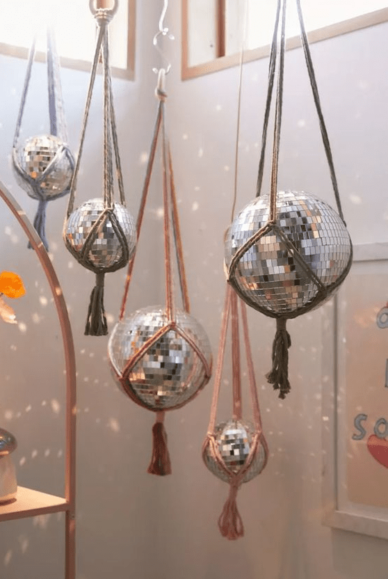 Hang disco balls using usual yarn to make your space more boho like, add tassels or fringe to them