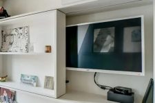 a TV hidden under a shelving unit that can slide and let you watch TV – this is a stylish and cool idea