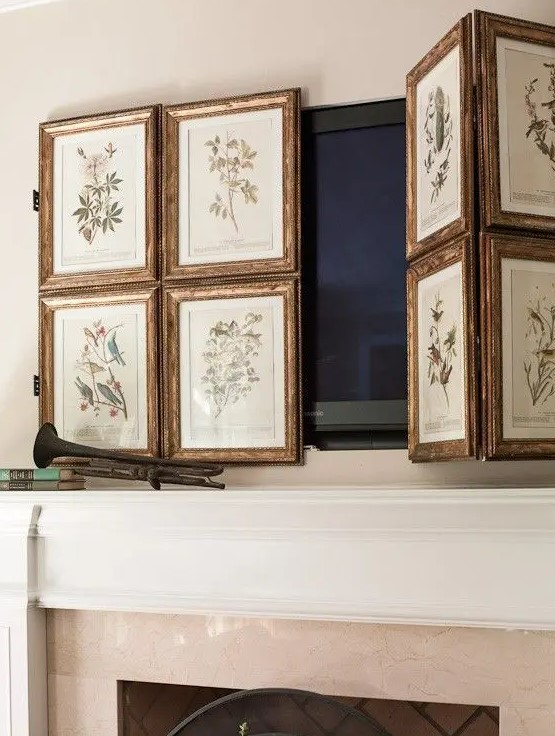 a TV over the fireplace hidden with a lovely gallery wall of vintage botanical posters is a lovely idea for a space with a vintage feel