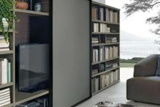 a bookcase with a sliding panel that can hide your TV easily and with style is a cool idea for a modern space