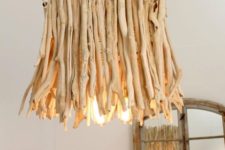 a chandelier made of bleached driftwood is a perfect option for a beach or a coastal house