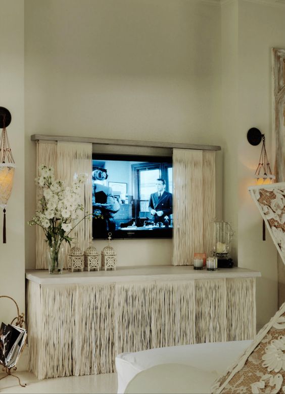 a cool storage unit with a matching sliding screen that hides a TV and keeps the space neat, sleek and elegant