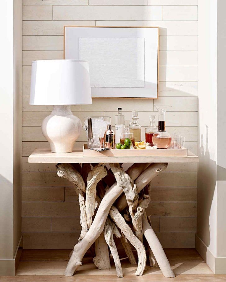 a-home-bar-made-of-a-piece-of-plywood-and-bleached-driftwood-branches-for-the-legs-is-a-stylish-idea.jpg