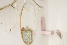 a large branch attached to the wall serves as a cool natural jewelry holder – what a lovely solution for a girl’s room