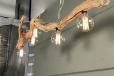 a large driftwood branch turned into an ultra-modern and super stylish pendant lamp