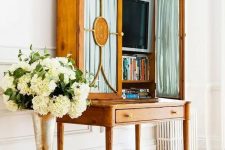 a refined vintage secretary style desk with a TV and books is a lovely idea to hide your TV with much elegance