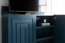 a super stylish art deco inspired navy TV lift cabinet is a fantastic solution for any space, from a living room to a bedroom