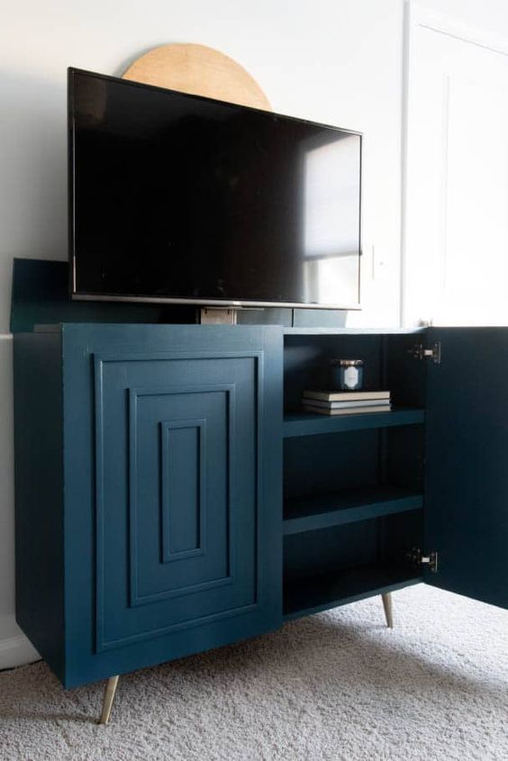 a super stylish art deco inspired navy TV lift cabinet is a fantastic solution for any space, from a living room to a bedroom