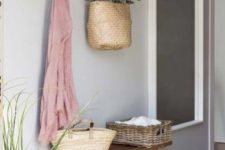 an entryway holder made of a branch on rope with hooks is a stylish rustic idea to go for
