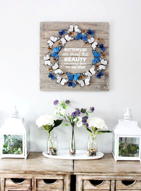 a chic artwork of a colorful buttefly wreath and white letters is a cool idea to bring a touch fo spring to the space