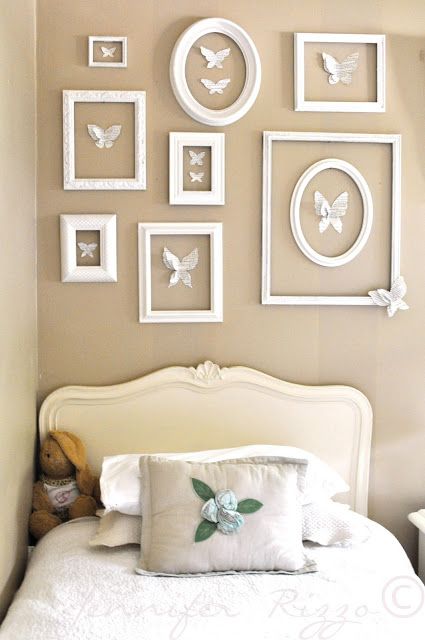 a gallery wall of empty frames with white paper butterflies is a cool idea to make your vintage space more refined